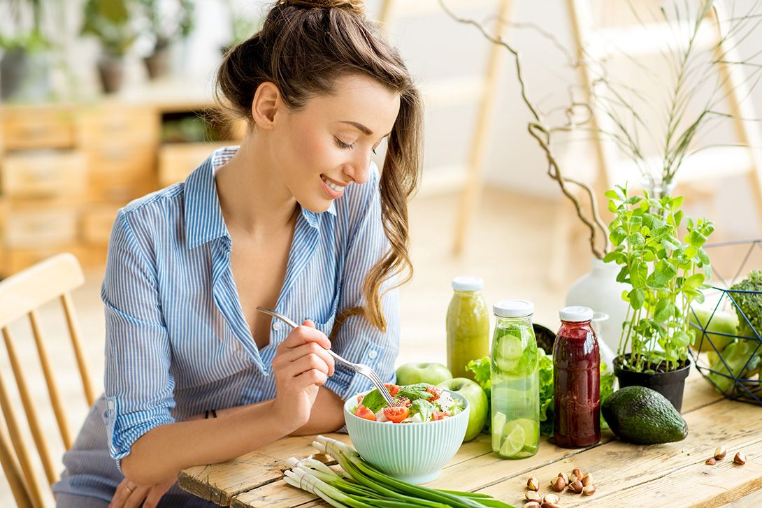 Woman eating a healthy salad in her home