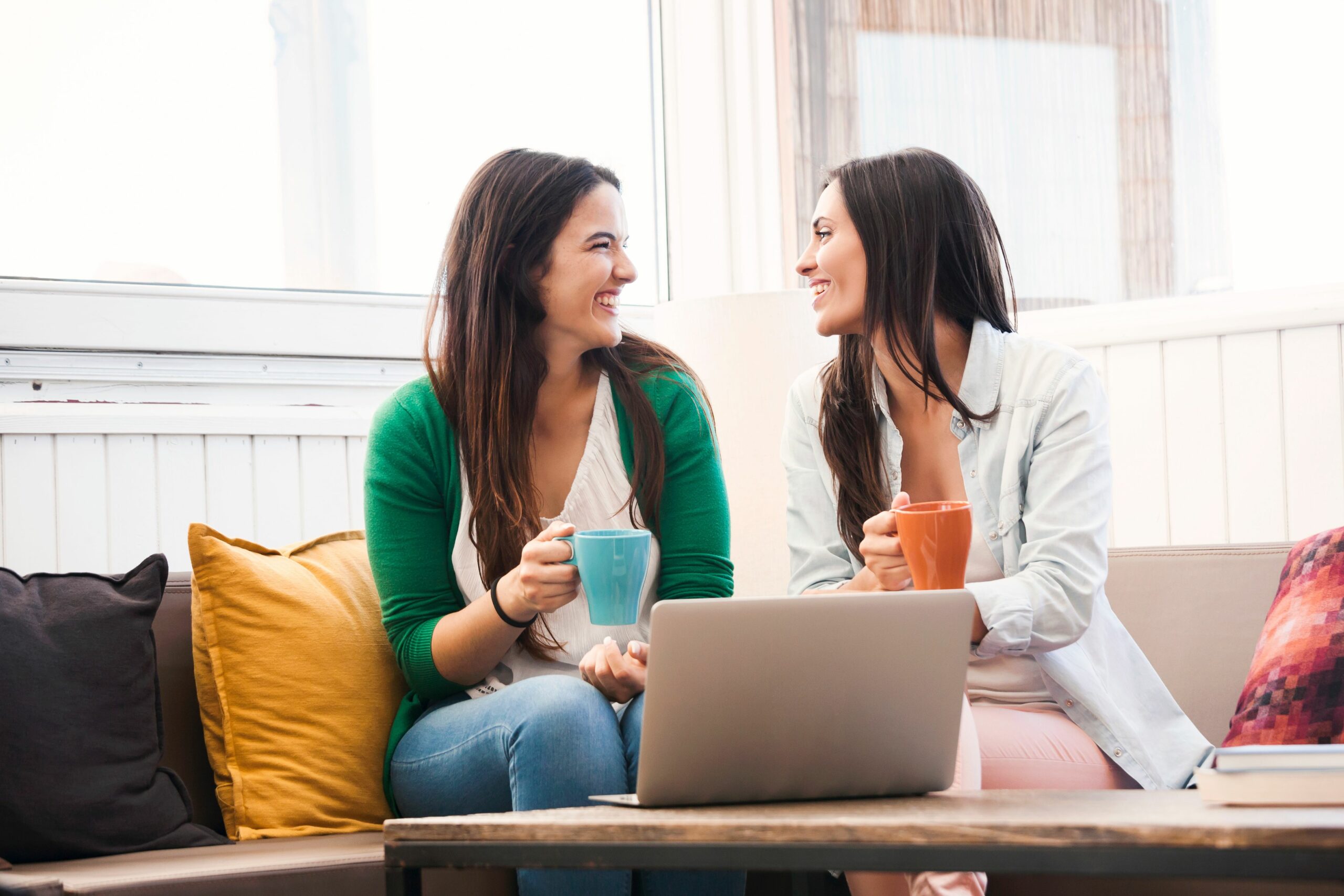 Women chatting while enjoying a cup of coffee scaled